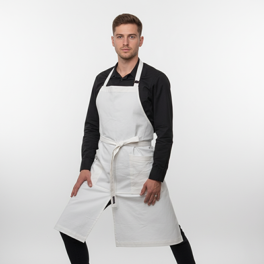 Man wearing a white apron on a plain background